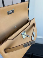 Hermes tan leather flap bag open interior with silver lock and strap