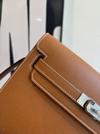 Brown leather flap bag close-up of front strap and silver-tone clasp hardware