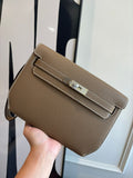 Hermes flap shoulder bag in brown textured leather with front buckle closure