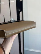 Hermes flap shoulder bag top edge and side seam detail in brown leather
