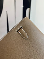 Hermes flap shoulder bag corner detail with engraved buckle and stitched edge