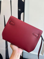 Red leather shoulder bag with curved flap and small corner flap tabs