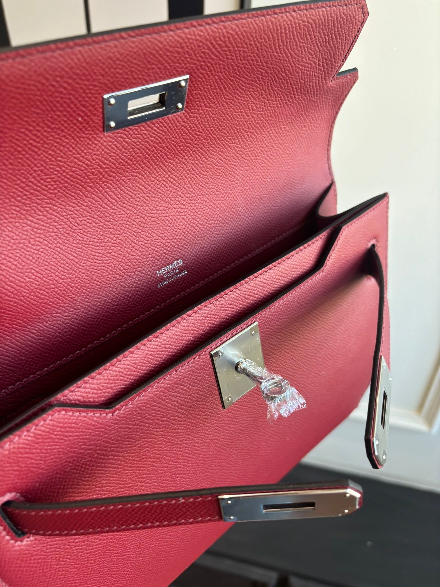 Red leather bag interior with front flap, pocket panel, and silver-tone clasp