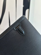 Hermes bag corner with stitched flap tab and secure closure detail