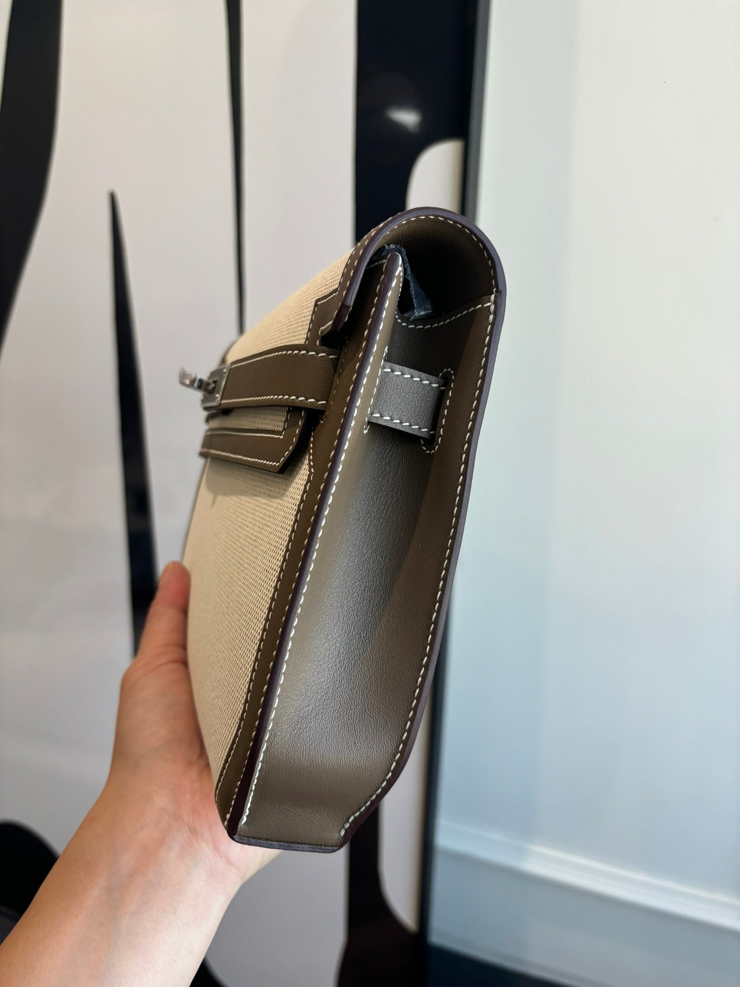 Hermes bag with structured beige body, brown edges, and two-tone top handle