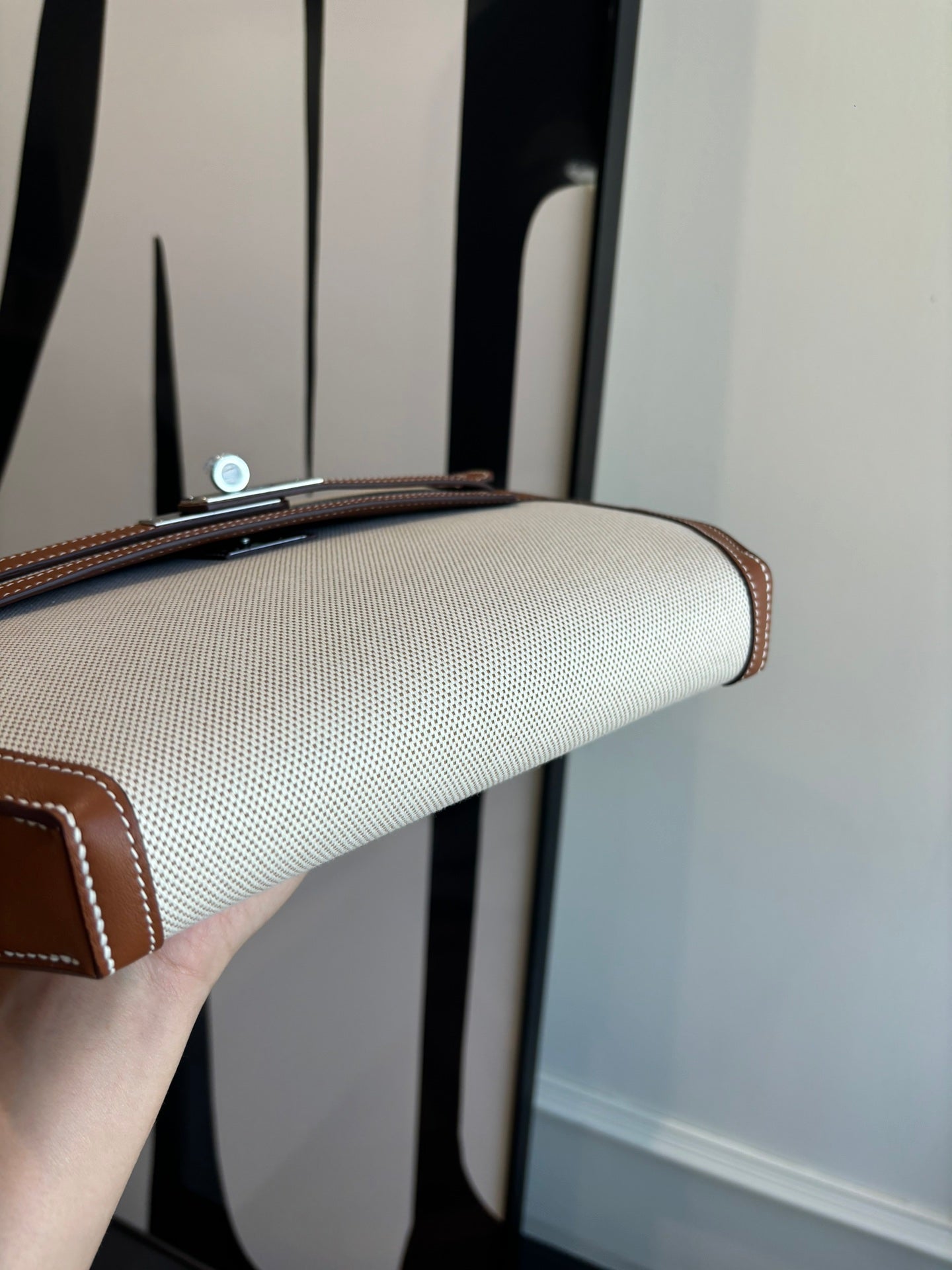 Hermes bag top edge detail, light canvas with brown leather border and metal hardware