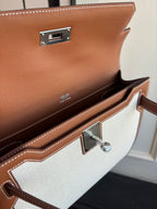Hermes bag interior view, brown leather flap with light canvas lining and clasp