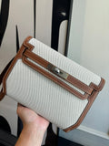 Hermes bag in light canvas with brown leather trim, front flap and buckle closure