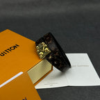 Louis Vuitton monogram leather bracelet with gold-tone buckle clasp, angled.
