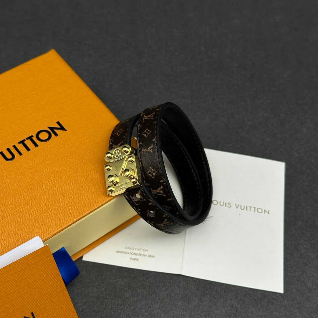 Louis Vuitton monogram leather bracelet with gold-tone lock clasp, ring style.
