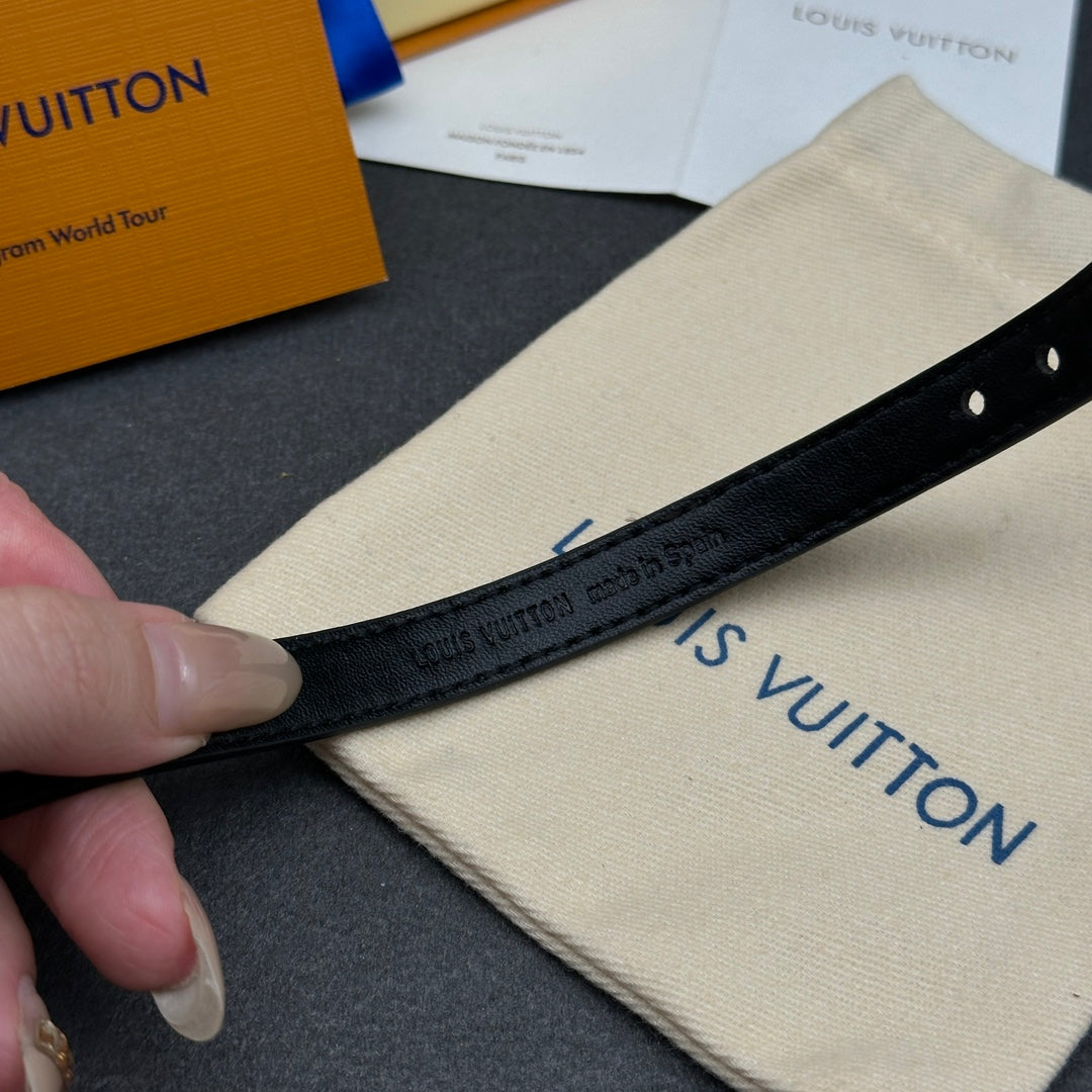 Louis Vuitton black leather bracelet strap with embossed logo and punched holes.