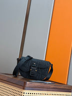 Navy Dior-style crossbody bag with embossed pattern, front flap and adjustable strap