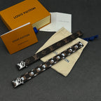 Louis Vuitton monogram strap with metal studs, shown with cream dust pouch