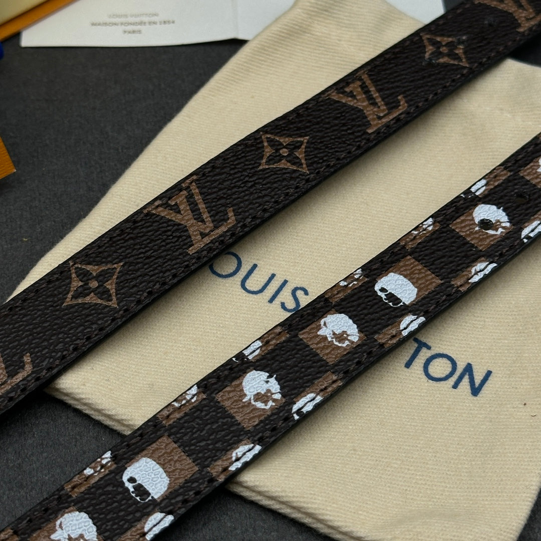 Louis Vuitton monogram strap close-up with gold-brown pattern and studs