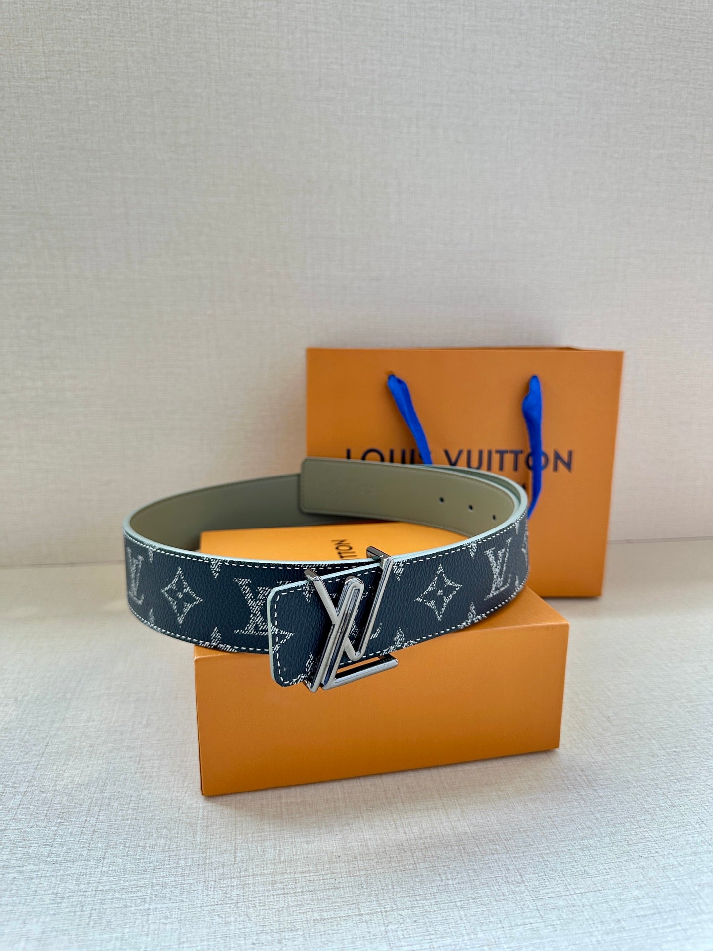 Louis Vuitton dark navy monogram belt with gold-tone V buckle and green lining.