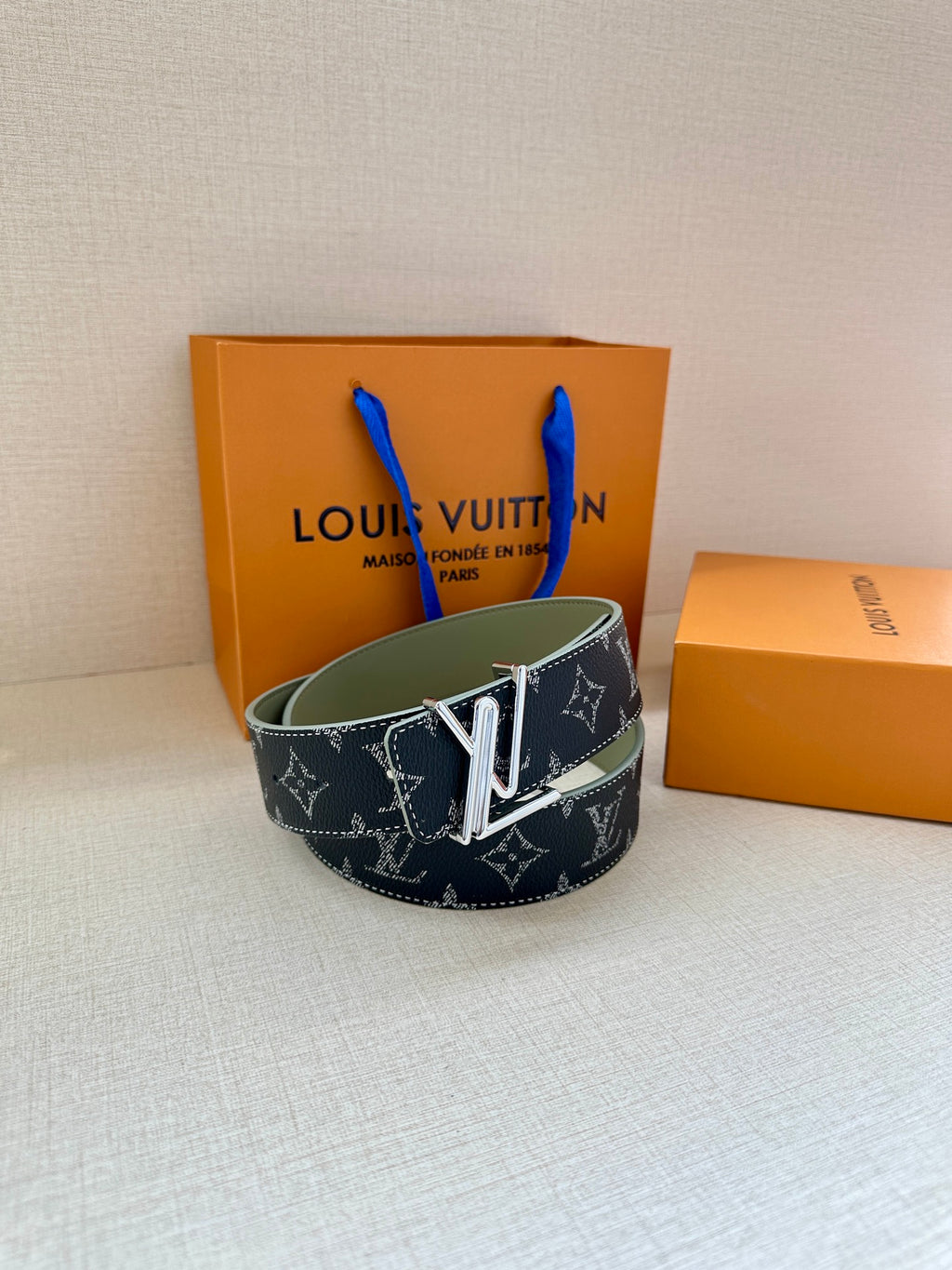 Louis Vuitton dark navy monogram belt with gold-tone V buckle and green lining.