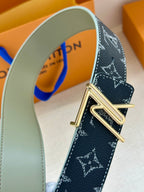 Louis Vuitton belt close-up: dark navy monogram strap with gold-tone metal buckle.