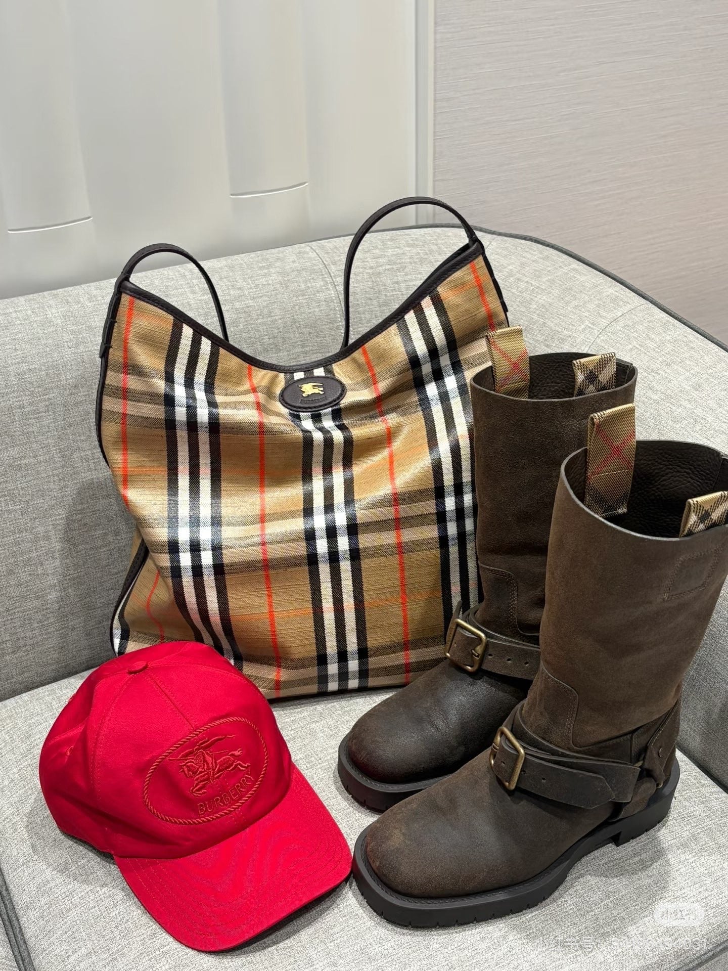 Brown suede mid-calf boots with buckle strap and side pull tab.