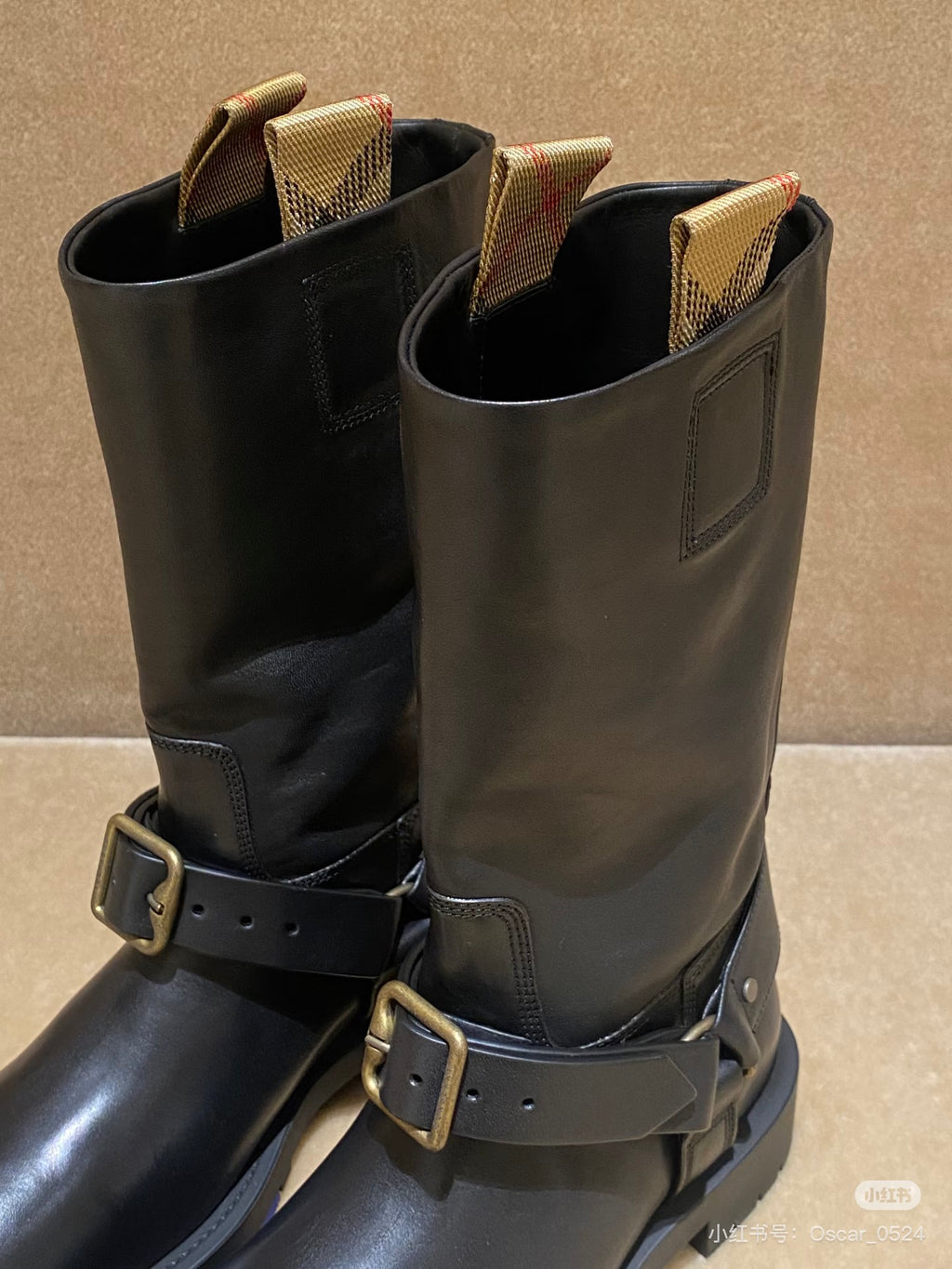 Dark brown leather mid-calf boots with side tab and double buckle straps.