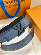 Louis Vuitton belt close-up, dark blue embossed strap with silver LV buckle side