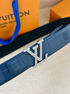 Louis Vuitton belt detail, dark blue strap with silver LV buckle and stud holes
