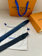 Louis Vuitton belt, dark blue strap with silver LV buckle, belt tail visible