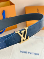 Blue leather belt strap with gold buckle close-up, embossed pattern