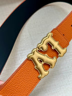 Orange leather belt close-up with gold-tone LV buckle and dark navy edge
