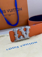 Close-up of orange leather belt with silver-tone LV buckle centerpiece