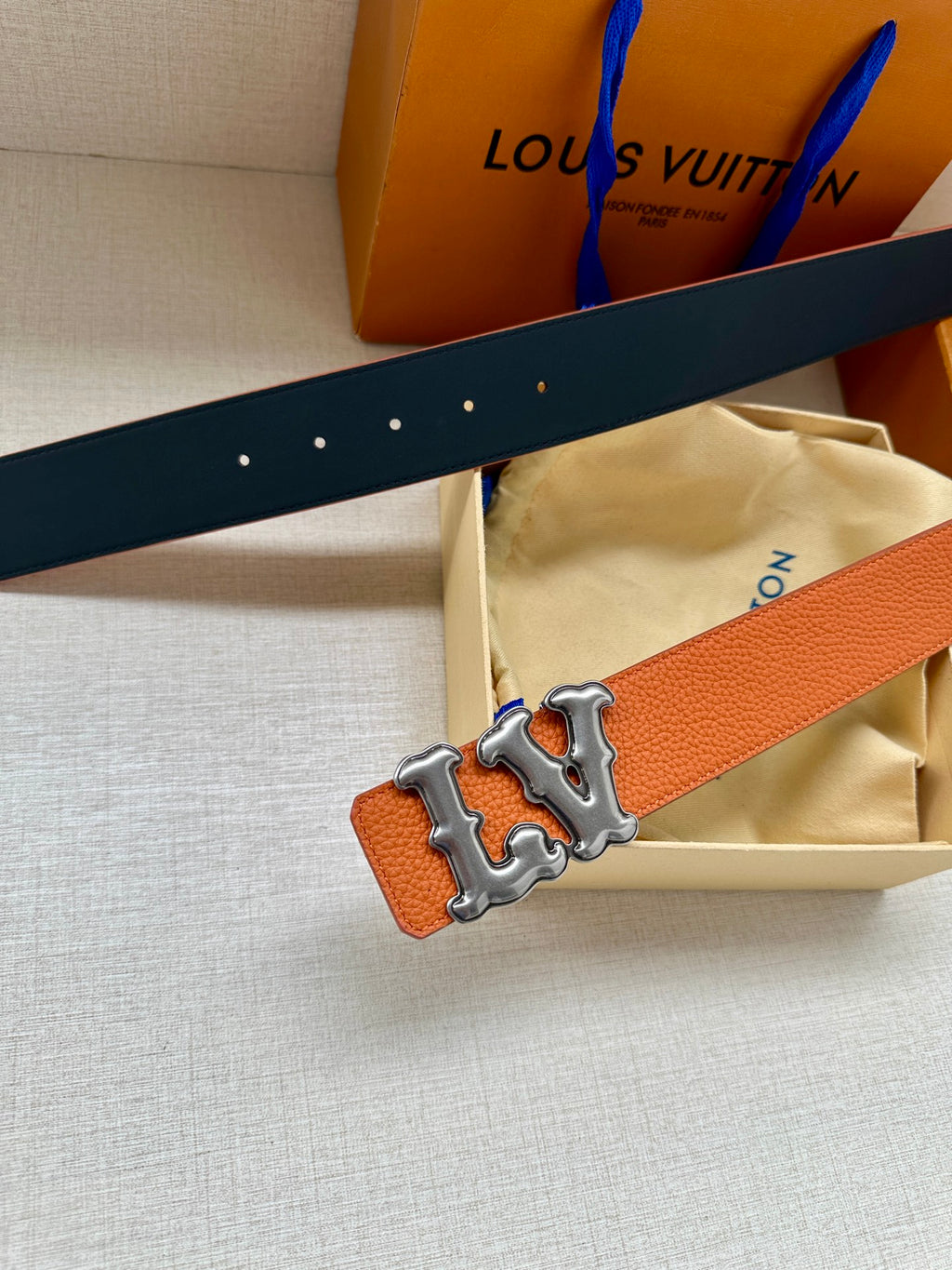 Dark navy leather strap with perforations and silver-tone LV buckle