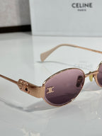 Oval sunglasses with rose gold frame and purple tinted lenses
