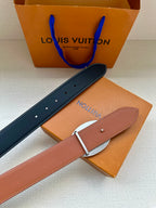 Navy and tan leather belt with silver buckle and rows of punched holes