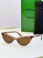 Rose-tone cat-eye sunglasses with brown lenses and gold-tone temple tips