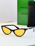 Tortoise cat-eye sunglasses with yellow tinted lenses and gold-tone temple detail