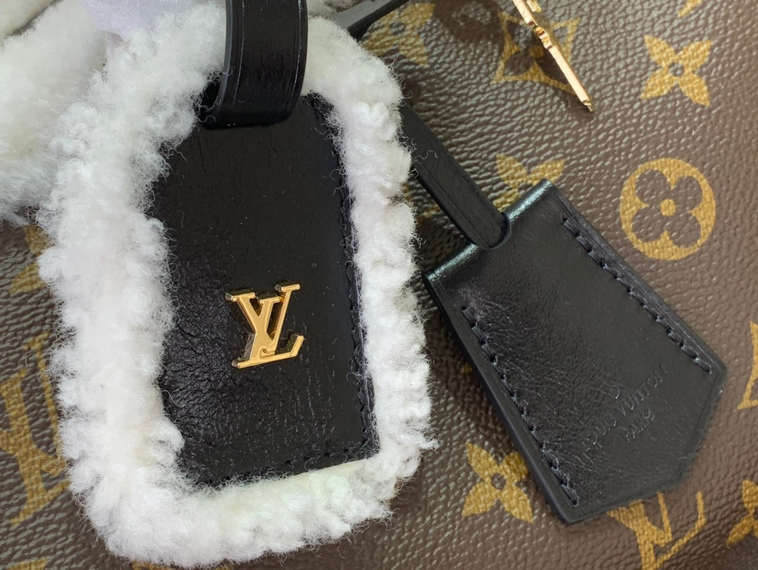 Black leather pocket with LV logo, white fuzzy trim on monogram canvas bag