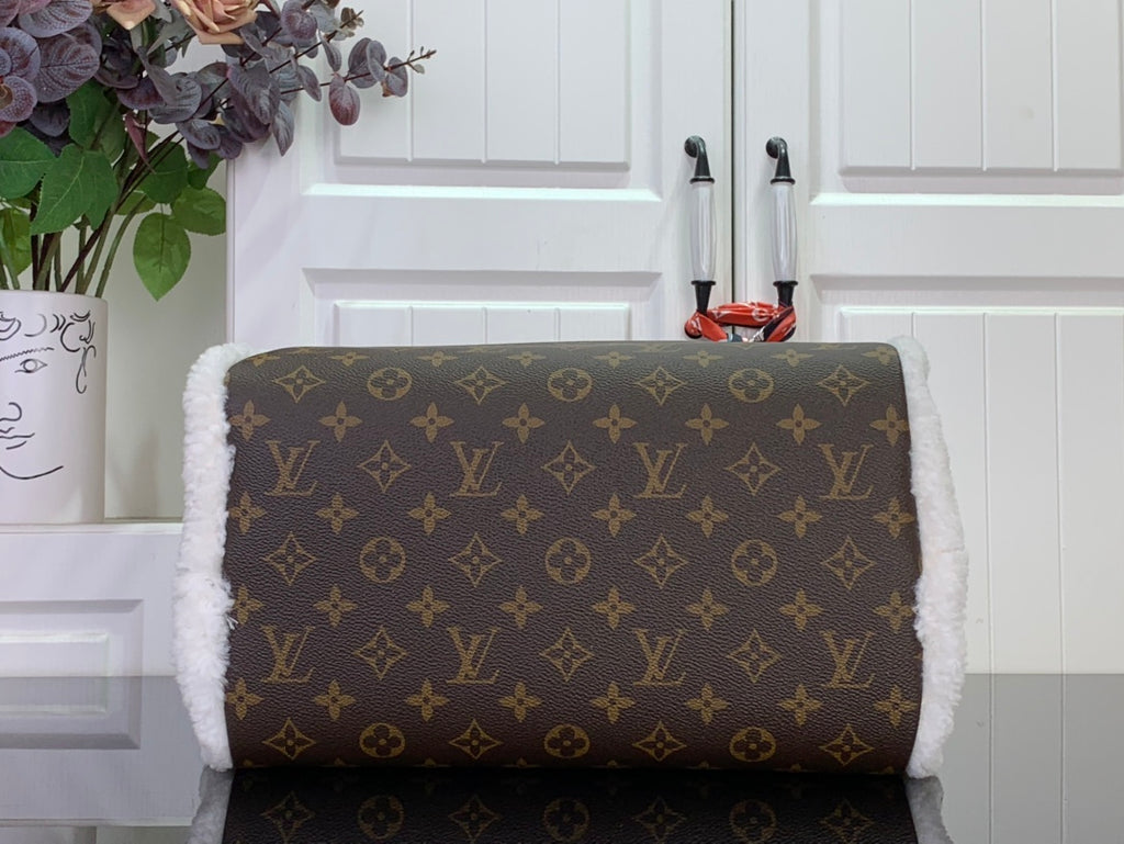 Monogram canvas handbag with white fuzzy lining and top zip, gold-tone hardware