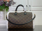 Monogram canvas handbag with curved top handles and white fuzzy trim, gold accents