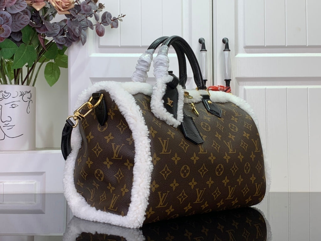 Monogram canvas handbag with white fuzzy tote handles and side pocket, gold hardware