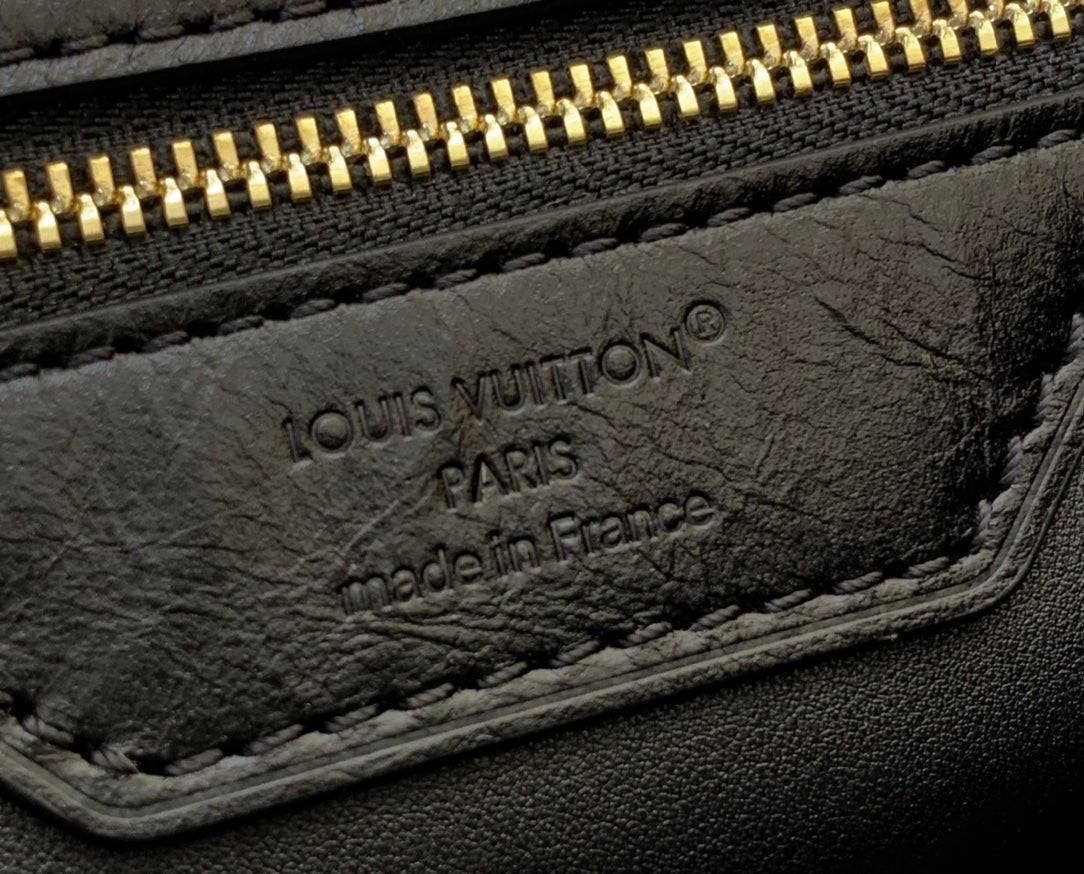 Louis Vuitton Paris leather tag, made in France, on inner pocket of bag