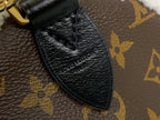 Black leather corner trim on monogram canvas bag with textured finish