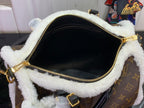 Black-lined inner compartment of monogram handbag with gold zipper and fuzzy edge