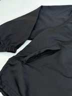 Black parka jacket with elastic cuffs and front zip pocket