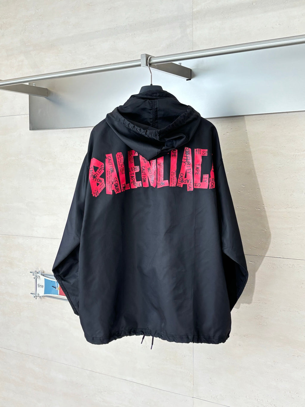Black long hooded jacket with pink BALENCIAGA logo on back