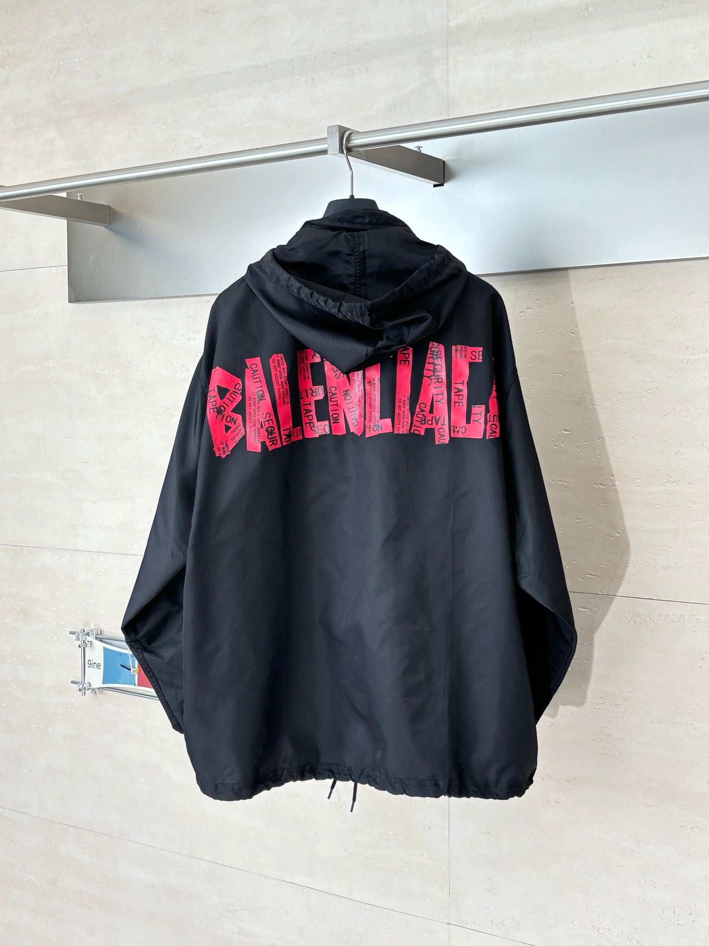 Black long hooded jacket with pink BALENCIAGA logo on back