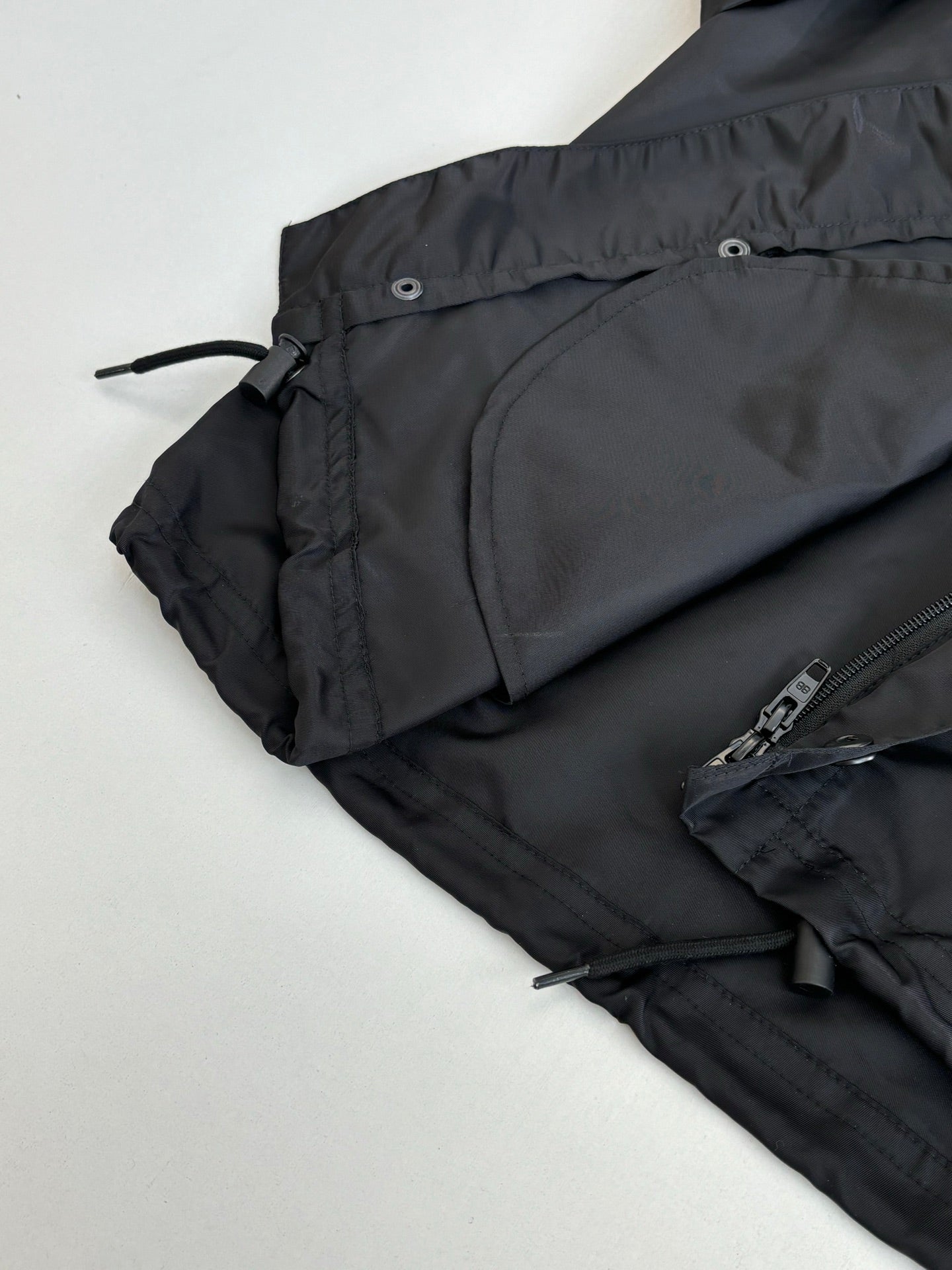 Black parka jacket with front pocket and adjustable drawstring waist