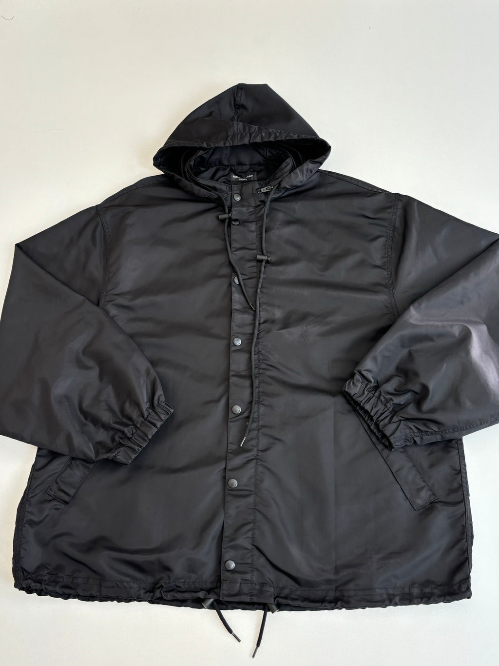 Black hooded parka jacket with full zipper and snap front