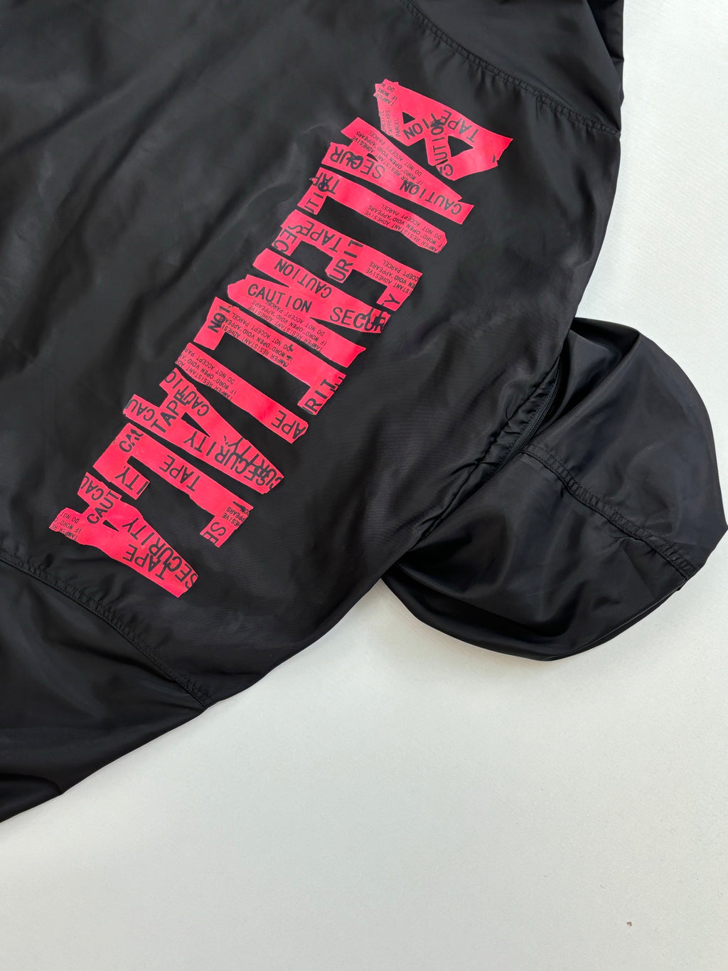 Balenciaga long-sleeve jacket, black with pink logo graphic on sleeve
