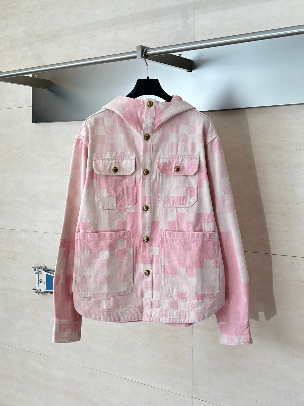 Pink hooded button-front jacket with patchwork check pattern and chest pockets