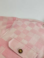 Pink check-pattern jacket hood edge with gold button detail