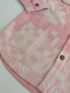 Pink hooded jacket yoke area with check pattern, top button, and front pocket